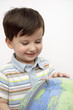 Hispanic boy looking at globe