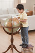 Korean boy looking at globe