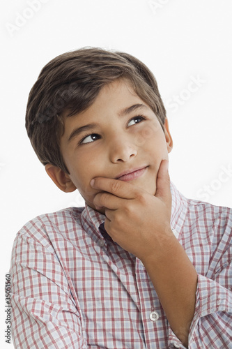 Photo: Hispanic boy thinking Hispanic boy thinking