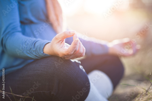 Photo: Pregnant mixed race woman practicing yoga in field Pregnant mixed race woman practicing yoga in field