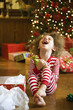 Excited mixed race boy opening Christmas gift