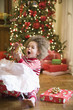 Mixed race boy playing with Christmas gift