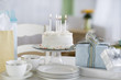 "Birthday cake, gifts with plates and cups"