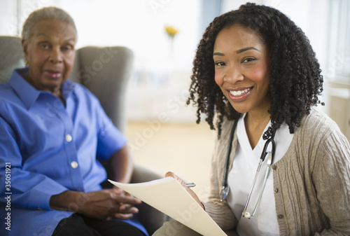 Photo: Nurse giving woman checkup Nurse giving woman checkup