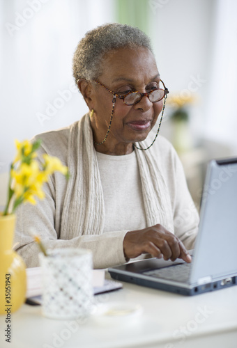 Photo: Black woman using laptop Black woman using laptop