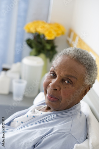 Photo: Black woman recovering in hospital bed Black woman recovering in hospital bed