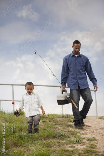Photo: Father and son going fishing together Father and son going fishing together
