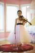 Asian girl in elegant dress playing violin