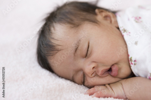 Photo: Mixed race newborn baby girl sleeping Mixed race newborn baby girl sleeping