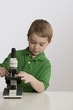 Caucasian boy using microscope