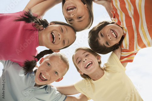 Photo: Smiling children huddling together Smiling children huddling together