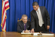 Hispanic businessman showing politician where to sign book