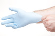 A doctor putting on a latex glove