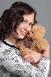 A portrait of a woman with a toy