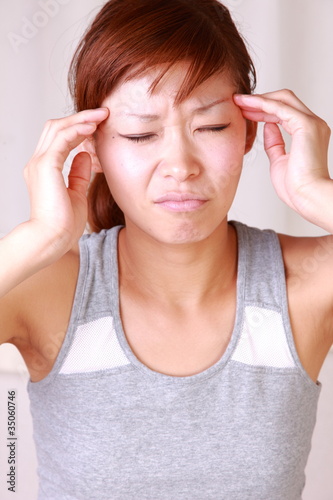 Photo: japanese woman woman suffers from headache japanese woman woman suffers from headache
