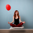 Levitation portrait of red caucasian girl with balloon.
