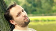 Young, sad, lonely man in the park
