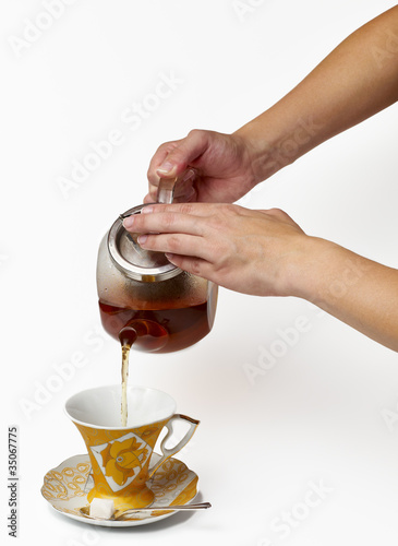 Photo: Tea being poured Tea being poured
