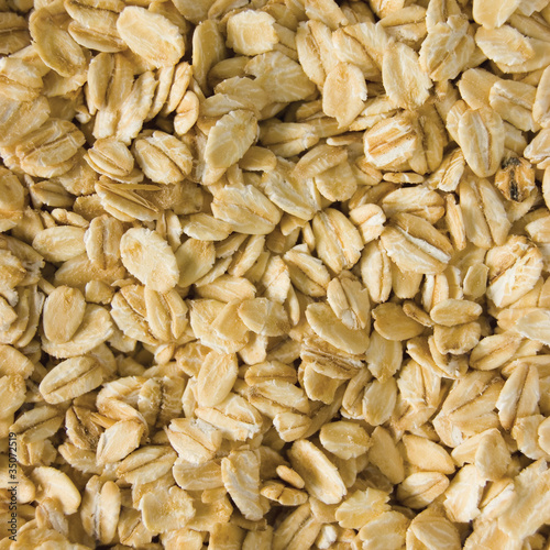 Photo: Oatmeal background, rolled raw oats macro closeup Oatmeal background, rolled raw oats macro closeup