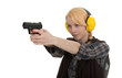 woman in protective receivers aiming pistol at shooting range