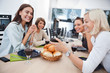 Photo: Smiling friends at dining table Smiling friends at dining table