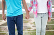 Teenage girl and boy holding hands