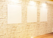 Empty frames on bricks wall in Gallery Interior