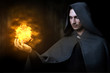 Halloween concept. Male wizard with fireball
