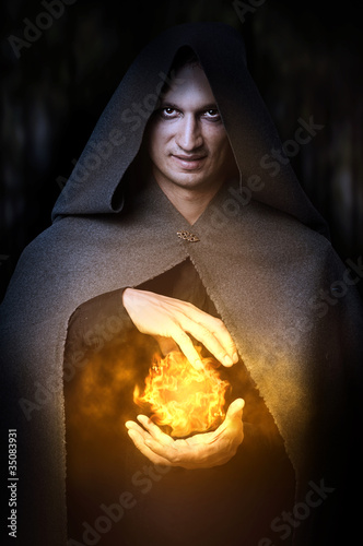 Photo: Halloween concept. Male wizard with fireball Halloween concept. Male wizard with fireball