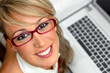 Attractive young female with glasses in front of a laptop Attractive young female with glasses in front of a laptop