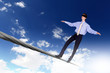 Business man balancing on the rope