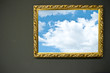 Antique empty golden frame with sky on grunge wall Antique empty golden frame with sky on grunge wall
