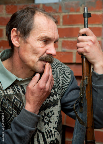 Photo: Man the hunter with a rifle Man the hunter with a rifle