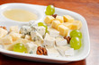 Cheese plate with grapes and honey