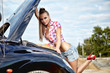 beautiful young woman repairing the car
