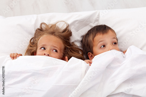 Photo: Kids afraid pulling the quilt on their heads Kids afraid pulling the quilt on their heads