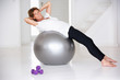 Senior woman using gym ball