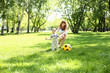 Little boy in the park playing with a ball