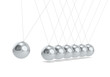 Pendulum. Newtons cradle White floor. Steel Balls.