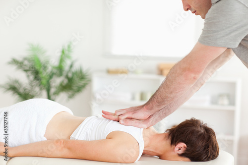 Photo: Masseur massaging female customer's back Masseur massaging female customer's back