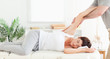 Chiropractor stretching woman's arm