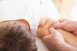 Man massaging a woman's shoulder