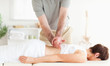 Charming Woman relaxing during a back-massage