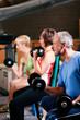 Foto: Senior people in a gym exercising with weights Senior people in a gym exercising with weights