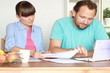 Happy couple calculating their bills by the table