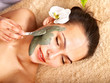 Young woman having clay body mask. Young woman having clay body mask.