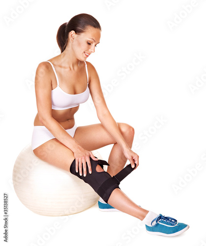 Photo: Woman with knee brace. Woman with knee brace.