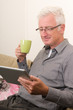 Photo: Senior working on a tablet pc Senior working on a tablet pc