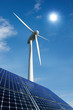 Solarmodule und Windkraftrad vor sonnigem Himmel Solarmodule und Windkraftrad vor sonnigem Himmel