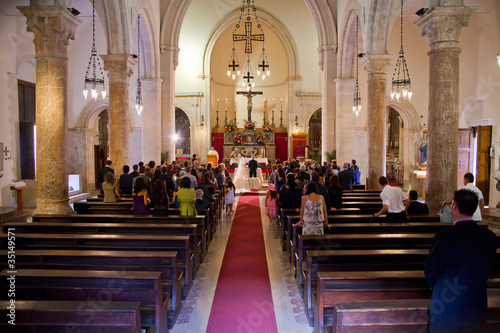 Photo: Couple getting married in a church Couple getting married in a church